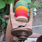 Colorful yarn on spinning wheel bobbin